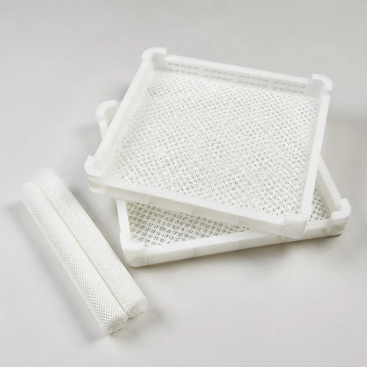 Silicone large-hole mesh dehydrator mat fitted in white dehydrator trays
