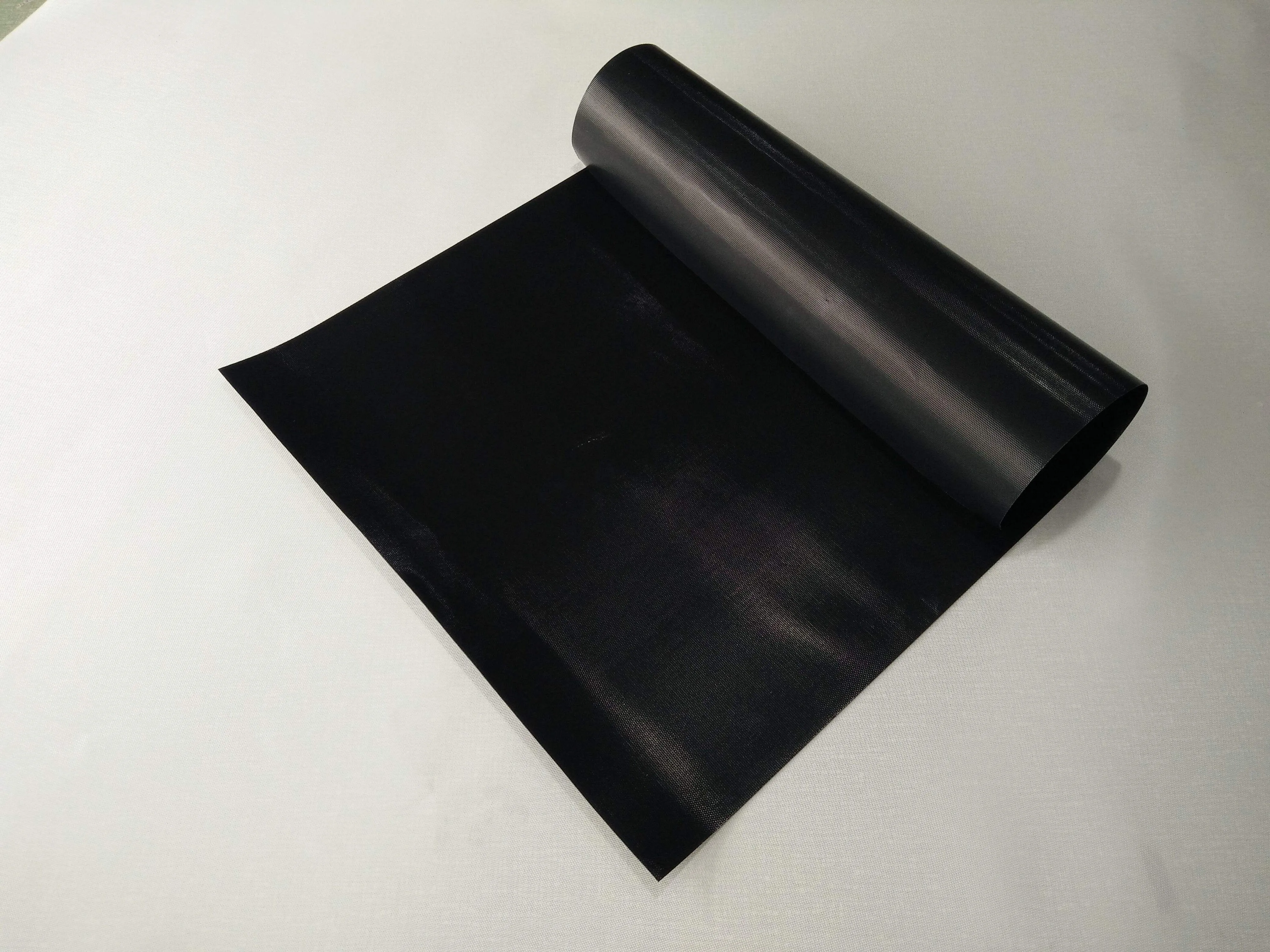 Close-up of black PTFE coated fiberglass non-stick surface