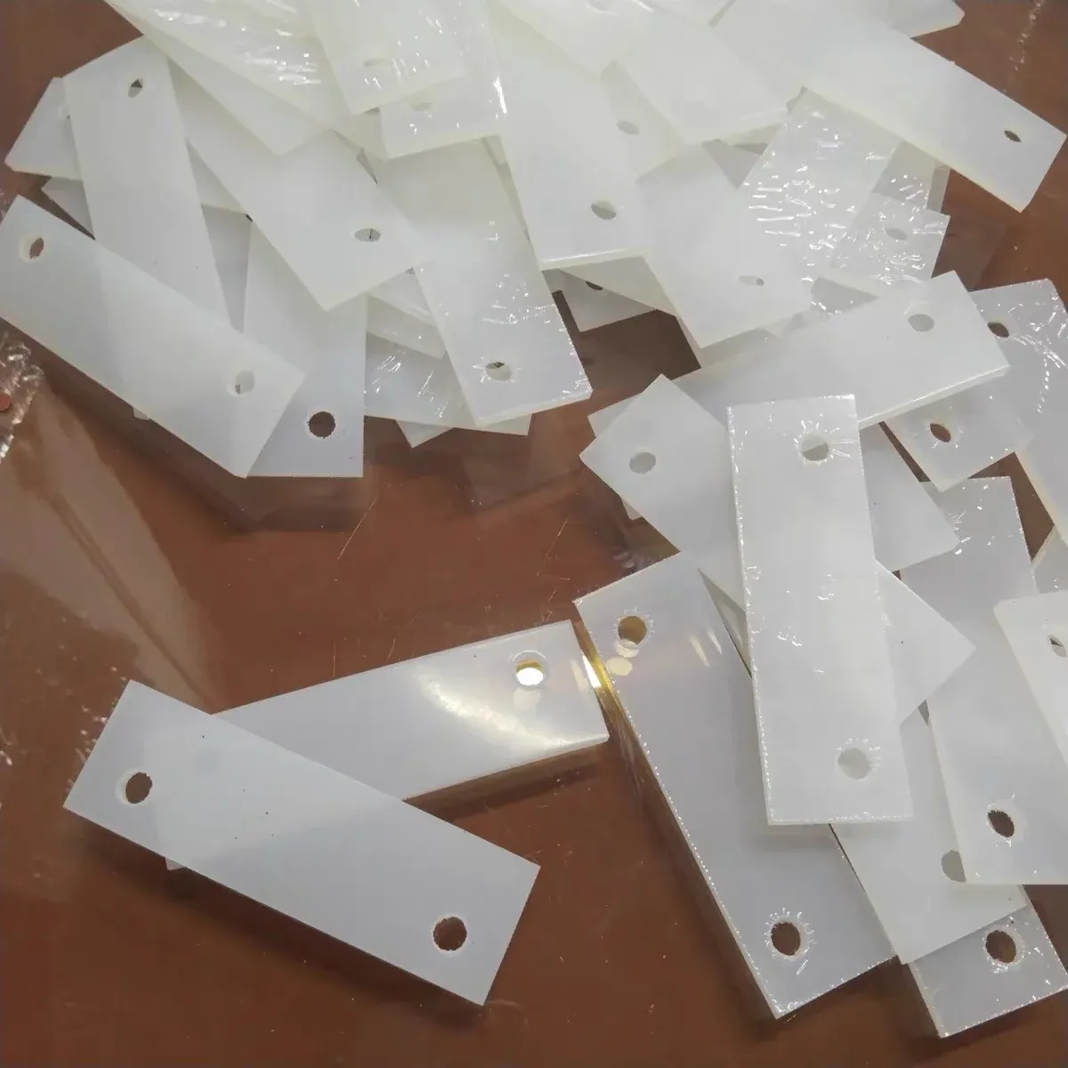 Custom-cut white silicone pads with mounting holes