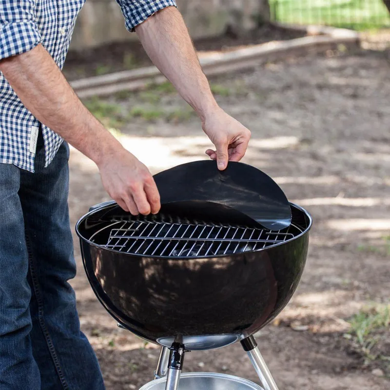 PTFE BBQ grill mat placed on outdoor kettle grill